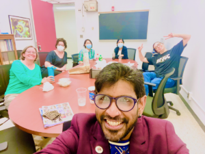 Members sitting around conference table while eating lunch