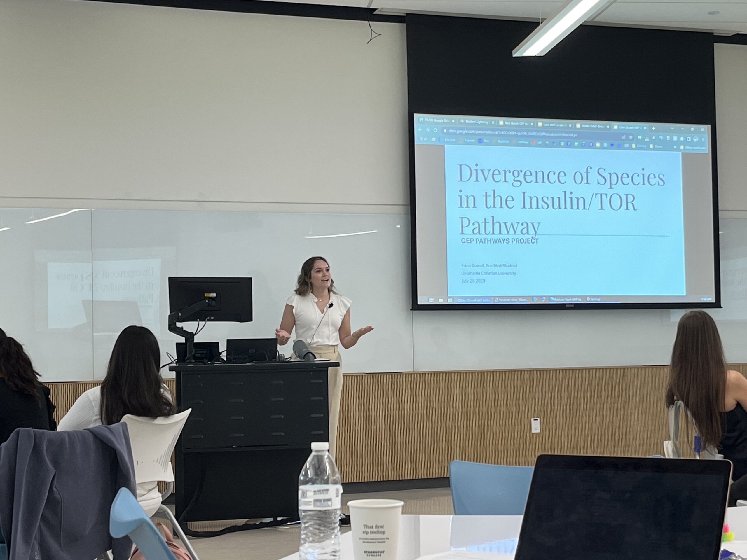 Student presenting on Divergence of Species in the Insulin/TOR Pathway