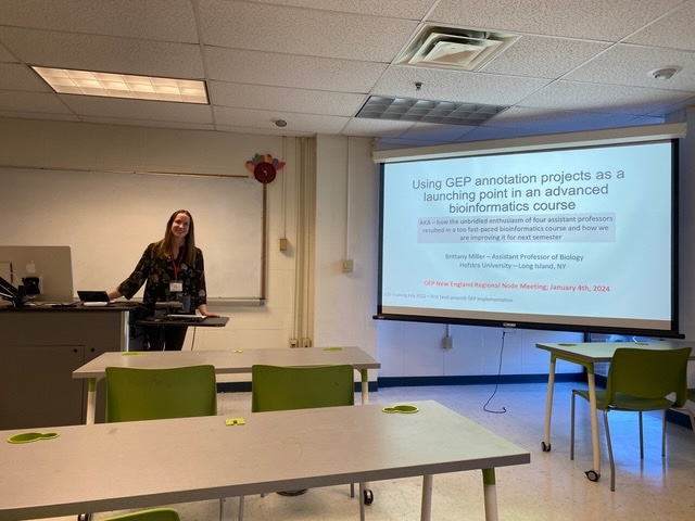 Brittany Miller posing before beginning her talk entitled Using GEP annotation projects as a launching point in an advanced bioinformatics course
